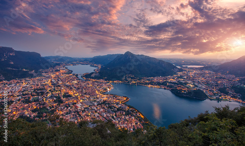 Panorama da Belvedere Lecco - Lago di Como. Evening aerial view panorama at sunset over Como lake of Lecco town. Resegone mount under sunlight. Amazing nature landscape. Popular Travel destinations