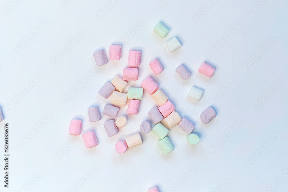 Top View of Pastel Shaped Marshmallow Candies with Some Scattered on the Pale white Table Top View of Pastel Shaped Marshmallow Candies with Some Scattered on the Pale white Table