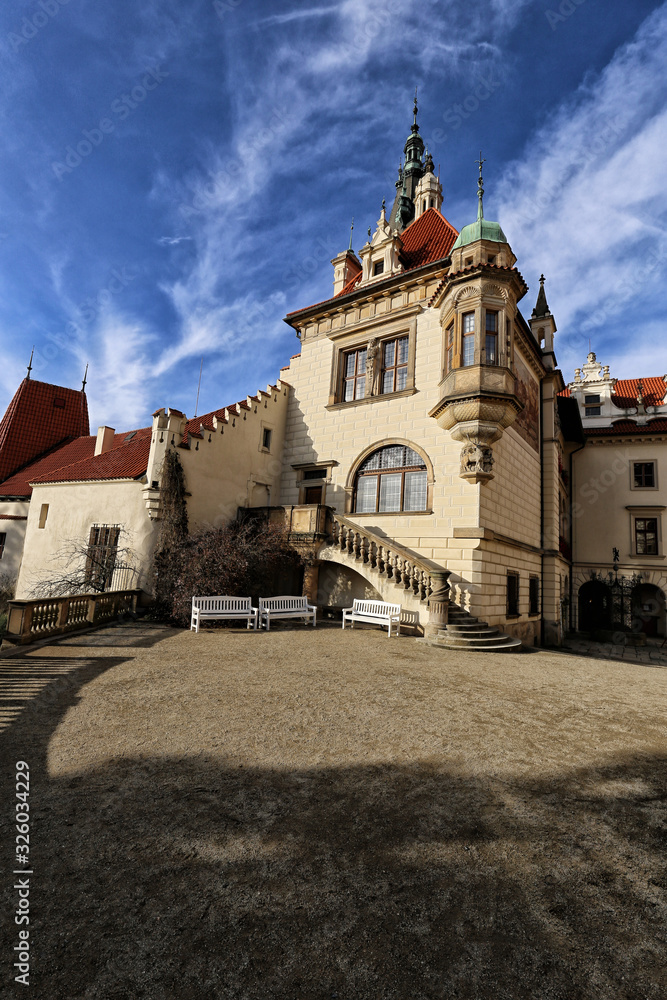 Palace of Pruhonice castle with red roof and cloudy sky