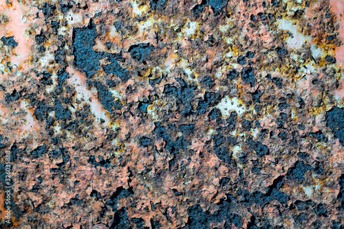 Rusty metal wall with cracked paint, background texture