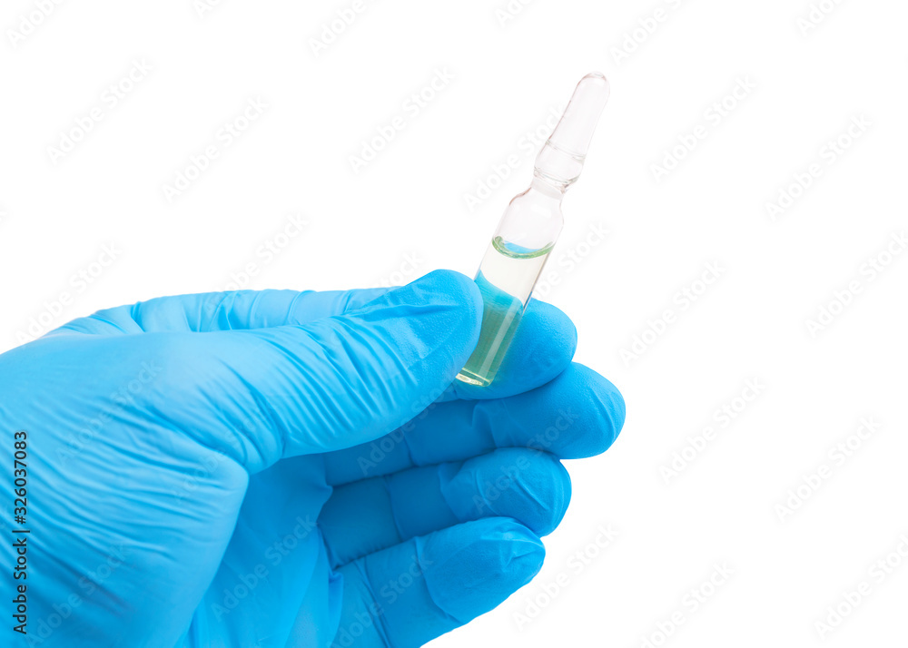 Glass ampoule in the hand of a doctor. Ampoule and doctor. Ampule in hand on a white background. Glass ampoule in the hand of a doctor. Ampoule and doctor. Ampule in hand on a white background.