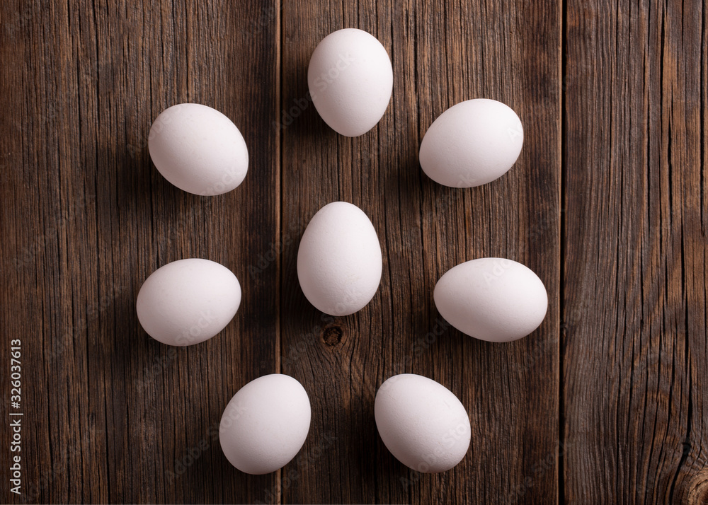 Fotografie White eggs on a wooden table top view