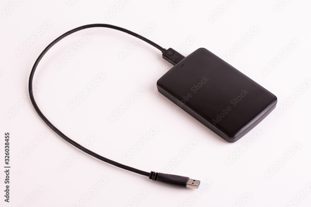 Hard drive close up. Portable hard drive with usb wire on a white background. Hard drive close up. Portable hard drive with usb wire on a white background.