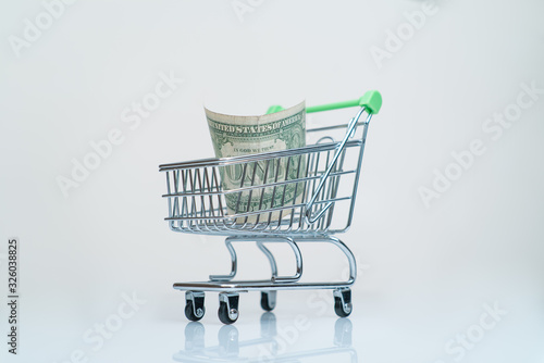 money one dollar in supermarket trolley shopping payment concept