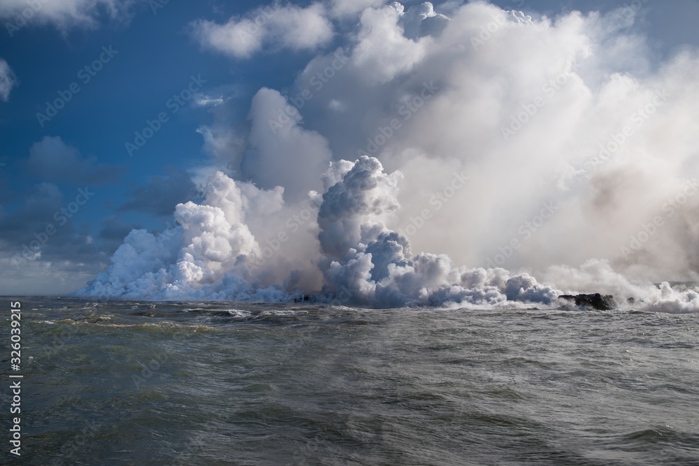 steam from the hot lava entering the sea