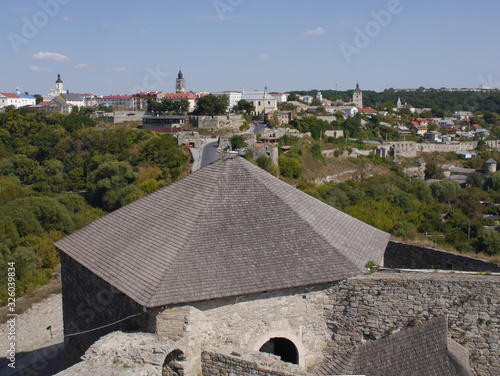 Medieval castle in the city of Kamyanets-Podilsky, Ukraine .  It is a formidable, strong fortress, whose walls are cut out of solid rock. The fortress stands at the top of a precipitous cliff .  photo