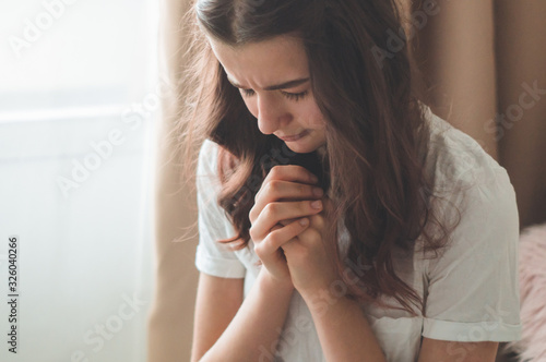 Fototapet Teenager Girl closed her eyes, praying in a in the living room