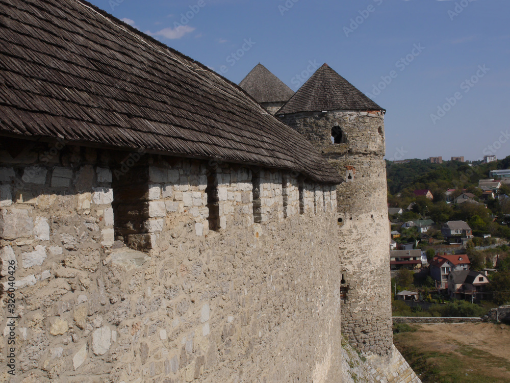 Medieval castle in the city of Kamyanets-Podilsky, Ukraine .  It is a formidable, strong fortress, whose walls are cut out of solid rock. The fortress stands at the top of a precipitous cliff . 