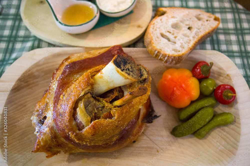 Roasted pork knee served on wooden plate