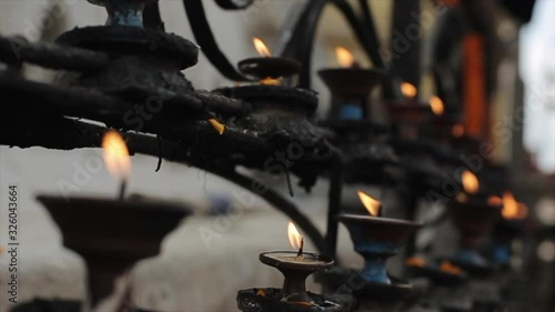 A close-up of a burning ritual in a nepalese temple. Burning candles, butter lamps. Kathmandu, Nepal. photo