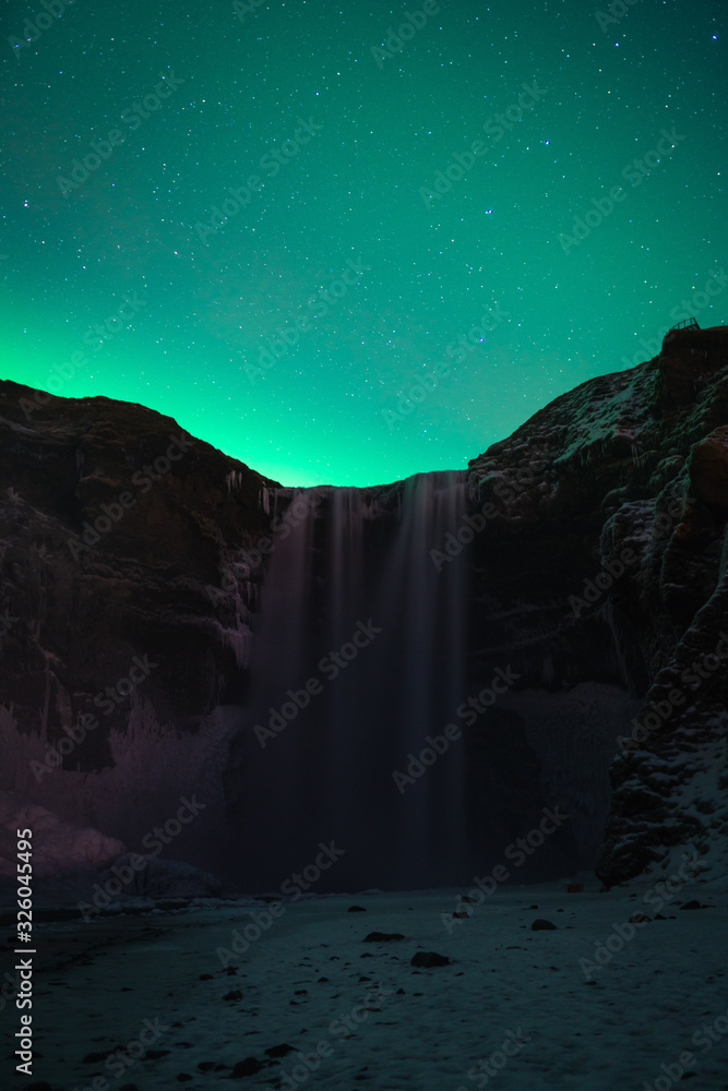 Beautiful Aurora at Skogafoss (Skoga Waterfall) in Iceland