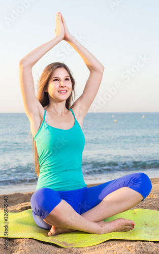 Portrait of sportswoman which is sitting and practicing asana © JackF