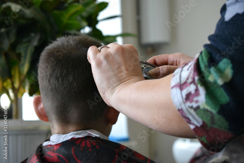 the Barber cuts the boy's hair