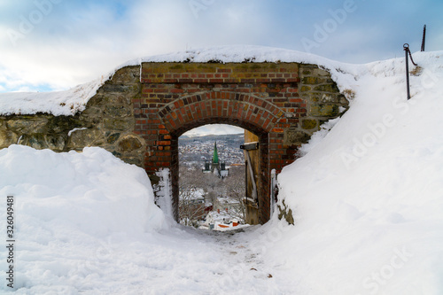 View of the cathedral through the Kristiansten Fortress gate. Winter panorama of the city of Trondheim. Norway photo