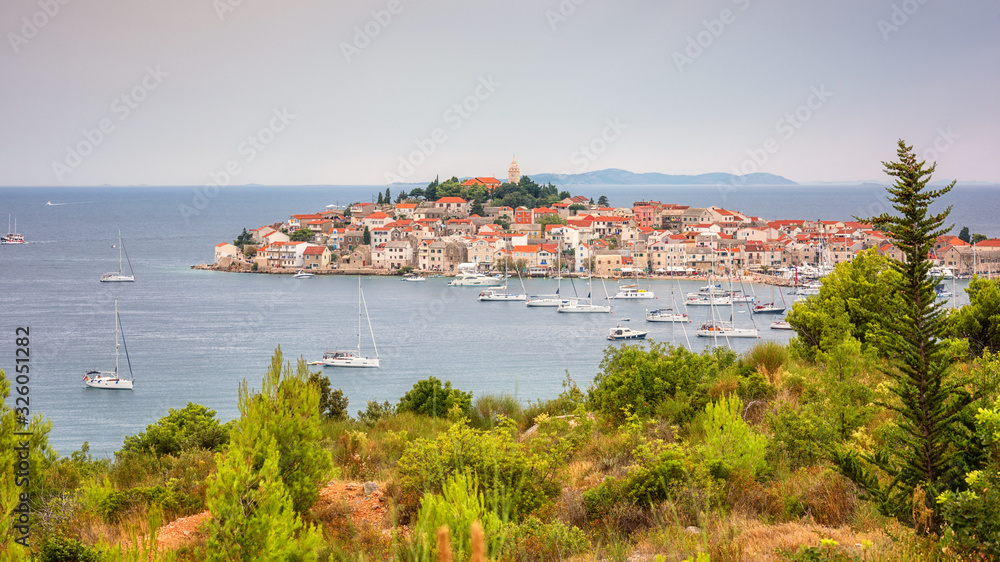 Amazing panoramic view of Primosten old town on the islet, Dalmatia, Croatia. Scenic seascape and city with medieval architecture, famous tourist resort on Adriatic seacoast, outdoor travel background