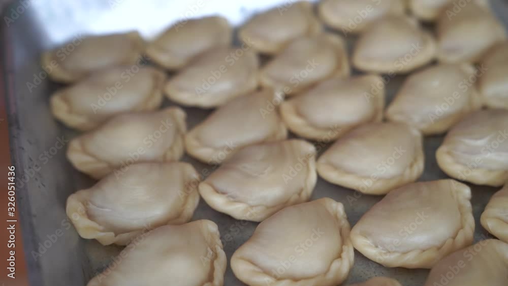 Closeup shot of pastry curry puff or karipap before fried on the tray Closeup shot of pastry curry puff or karipap before fried on the tray
