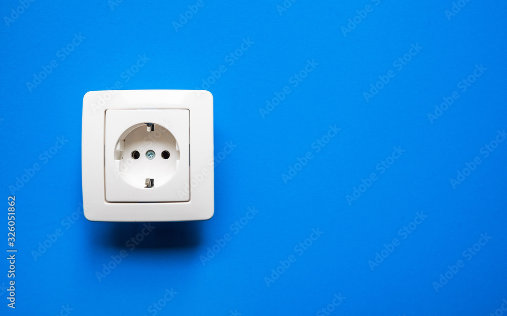 white electrical outlet on isolated blue background white electrical outlet on isolated blue background