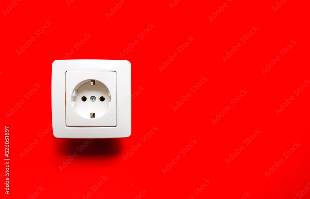 white electrical outlet on isolated red background white electrical outlet on isolated red background