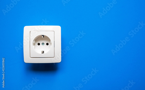 white electrical outlet on isolated blue background