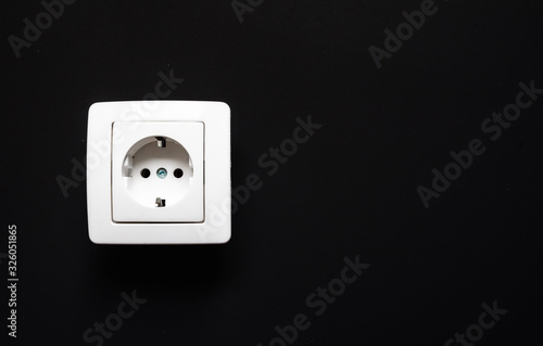 white electrical outlet on isolated dark gray background