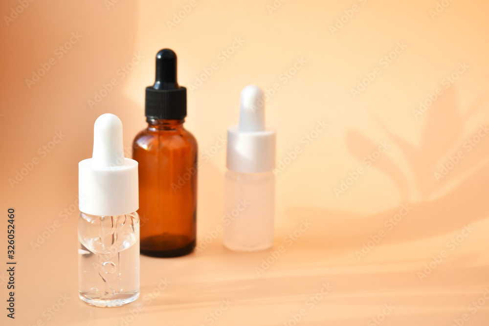 Different cosmetic bottles on the bed background, with contrasting shadows, organic product, Alternative medicine. Copy space.