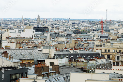 Paris skyline with roofs  chimneys and mansard stores. Typical old Paris architecture  beautiful facades of residential buildings. City life  european lifestyle and expensive real estate concept.