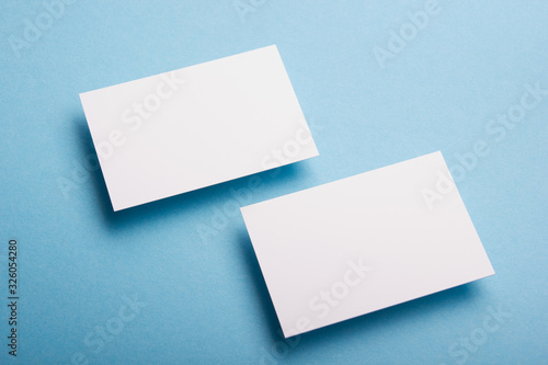 Business card blank on wooden background. Corporate Stationery, Branding Mock-up. Creative designer desk. Flat lay. Copy space for text