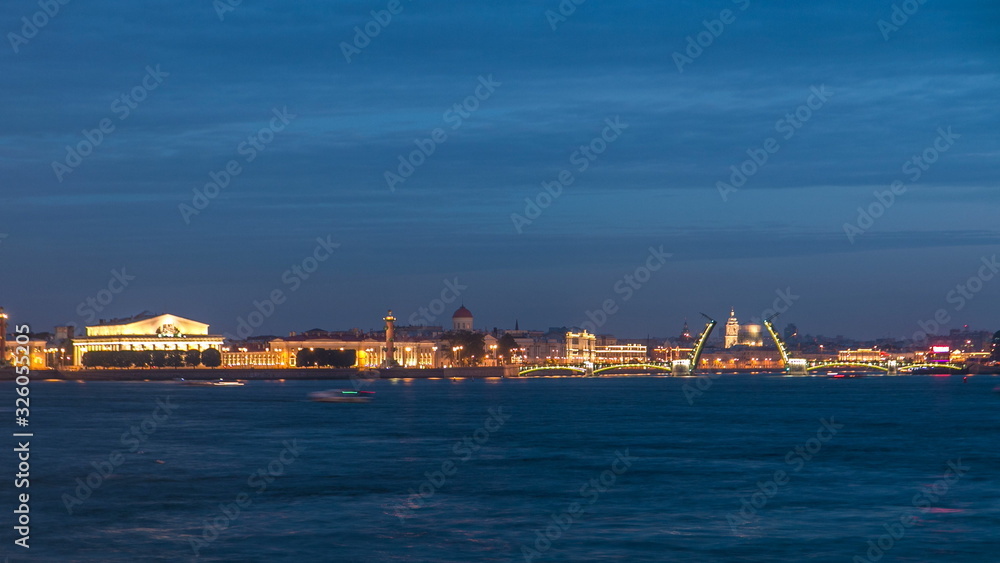 Night view of spit of Vasilyevsky Island and opened Birzhevoy Bridge with rostral column timelapse, Saint Petersburg, Russia.