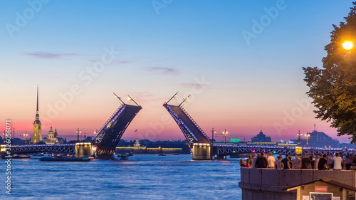 View of the closing Palace Bridge timelapse, which spans - the spire of Peter and Paul Fortress photo