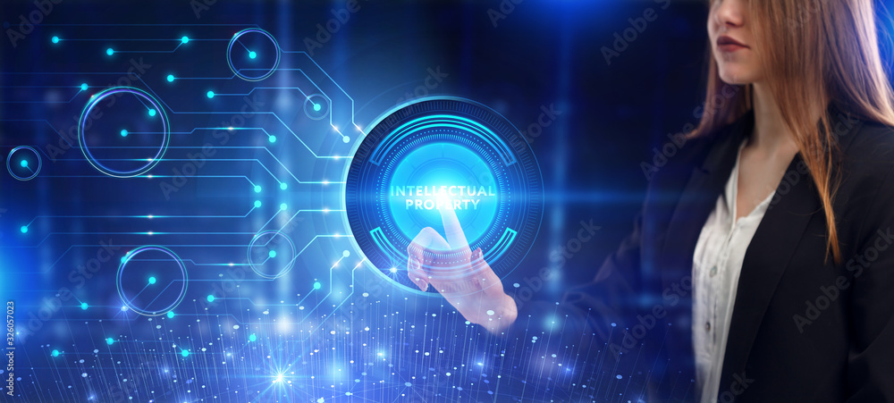 Business, Technology, Internet and network concept. Young businessman working on a virtual screen of the future and sees the inscription: Intellectual property Business, Technology, Internet and network concept. Young businessman working on a virtual screen of the future and sees the inscription: Intellectual property