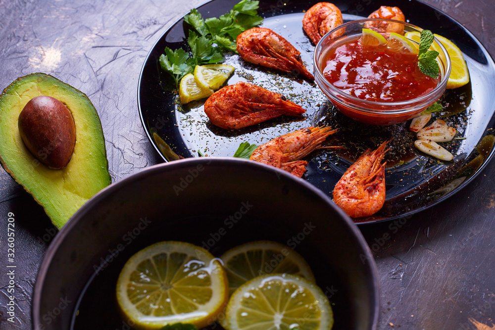 prawns fried with spices with sauce and lemon slices