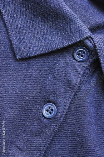Navy blue color polo shirt close up. Button-up plain t-shirt, collar neck clothes detail. Fashion clothes and shopping concept, plain polo shirt close up top view 