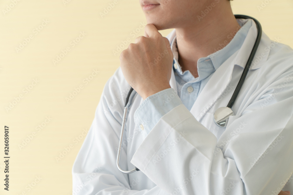 Portrait of Asian young doctor with arms crossed holding stethoscope in hospital emergency lap. Concept of healthcare patient lifestyle and medical.
