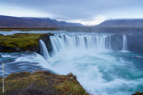 Godafoss waterfall. Beautiful landscape in Iceland. Cloudy sky with waterfall and smooth water flow