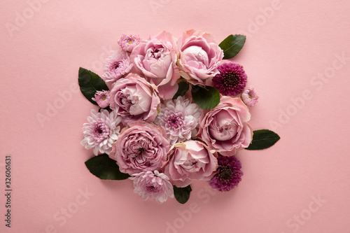 top view of blooming spring flowers in bouquet on pink background