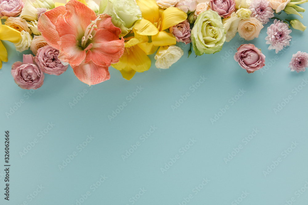 top view of spring flowers on blue background top view of spring flowers on blue background