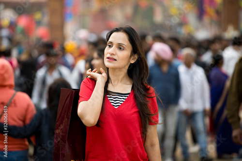 Woman holding shopping bags at street market