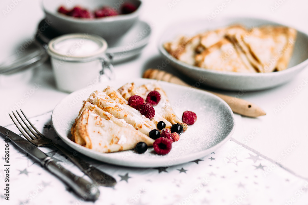 Pancakes with wild berries in a plate.Maslenitsa Pancakes with wild berries in a plate.Maslenitsa