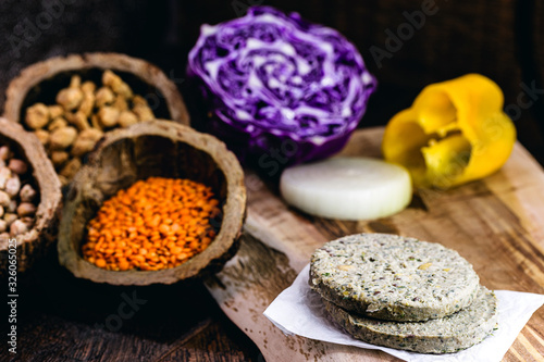 raw soy vegan burger, without frying, on wooden background.Vegan food and healthy living concept.