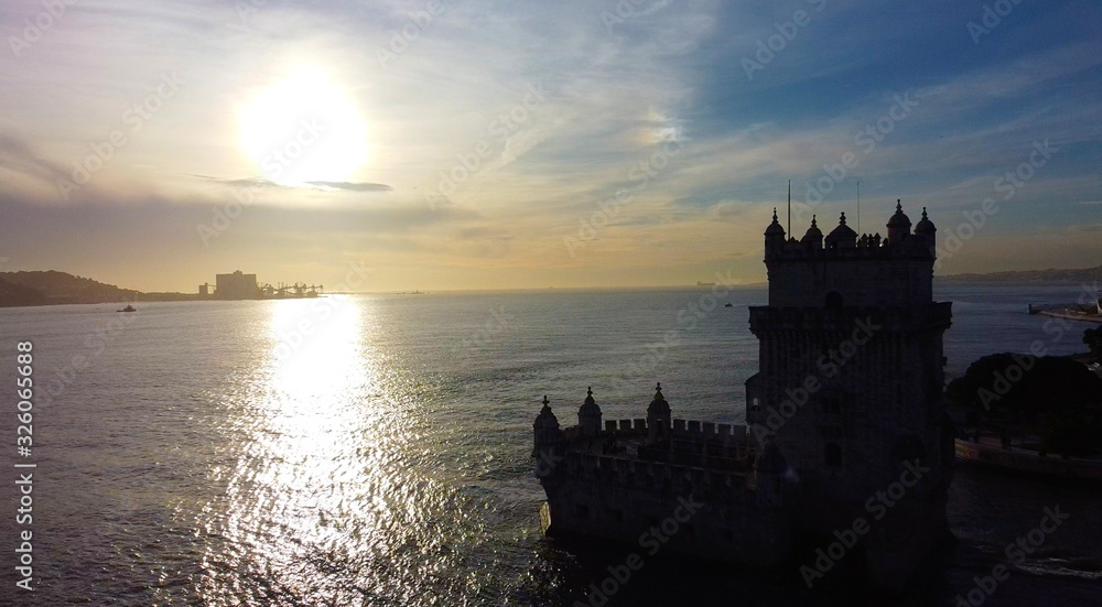 sunset over the sea on tower of belem in portugal
