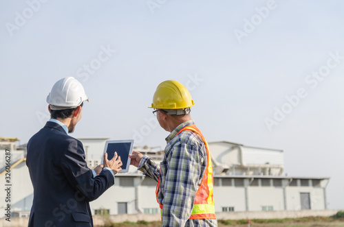 construction engineer standing in a conversation on the construction site
