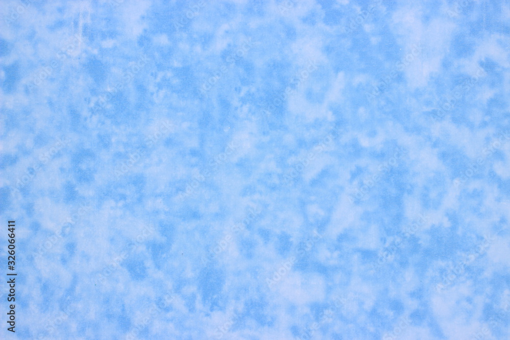 A sheet of plastic decorated with abstract, blue-white indistinct spots that look like small clouds