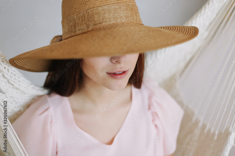 Close-up portrait of a beautiful smiling girl in a hat. Summer beauty. Romantic shot. Happy pretty young woman Close-up portrait of a beautiful smiling girl in a hat. Summer beauty. Romantic shot. Happy pretty young woman