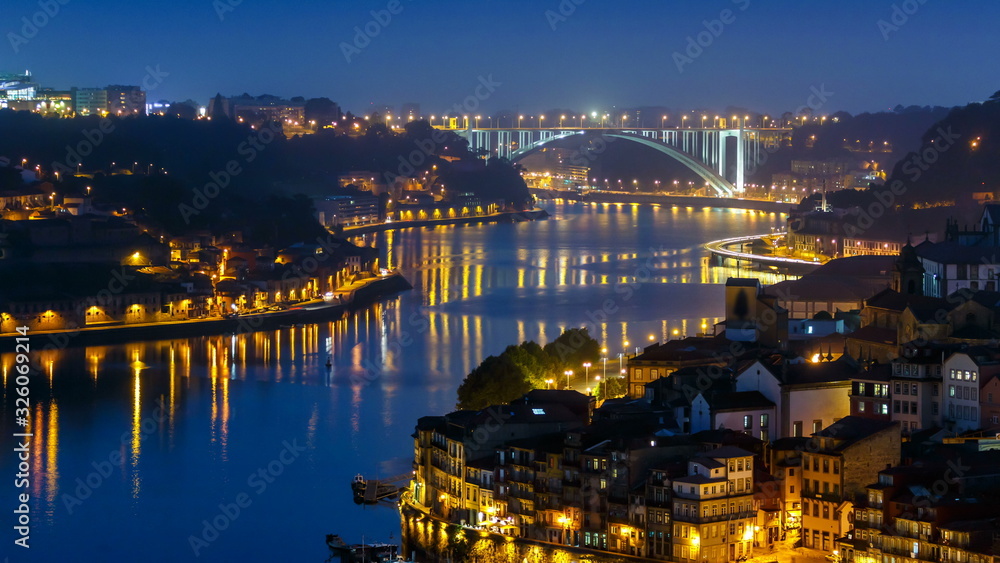 City of Porto and Gaia at night by the Douro river timelapse in Portugal, Arrabida Bridge at the far end.