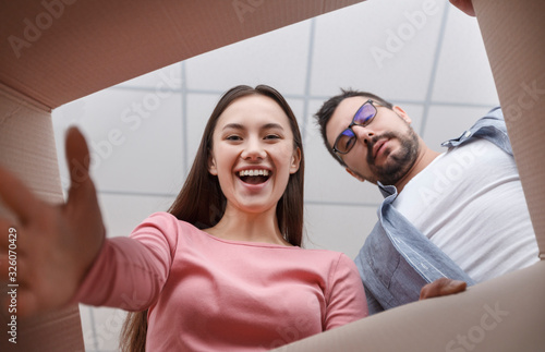 Woman and man are looking into box photo