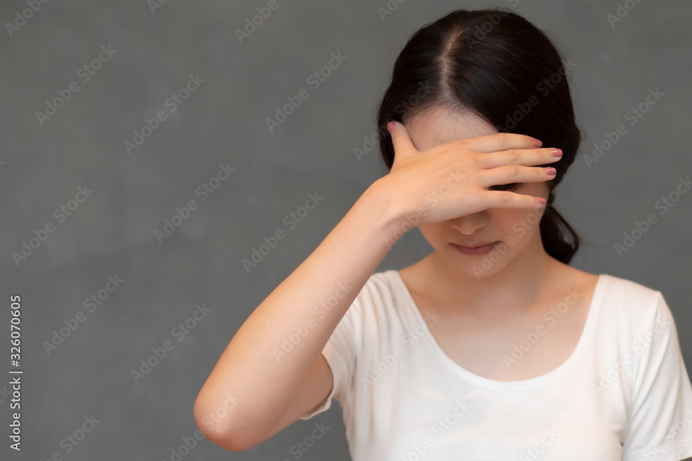sick woman doing facepalm due to fever or headahce; concept of stress, depression, biohazard, biological hazard, health care, coronavirus outbreak, sickness containment, COVID-19 coronavirus