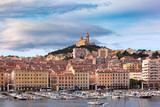 The old Vieux Port and Basilica Notre Dame de la Garde in the historical city center of Marseilles on sunny day, France