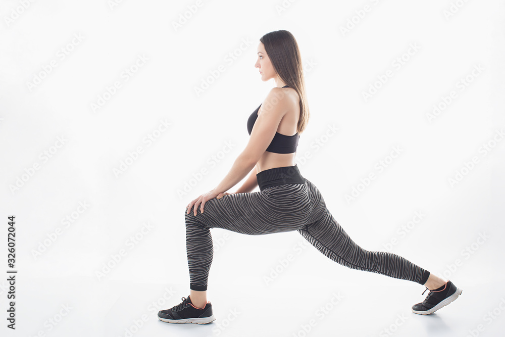 Fitness woman doing lung exercises for leg muscle training on a white background