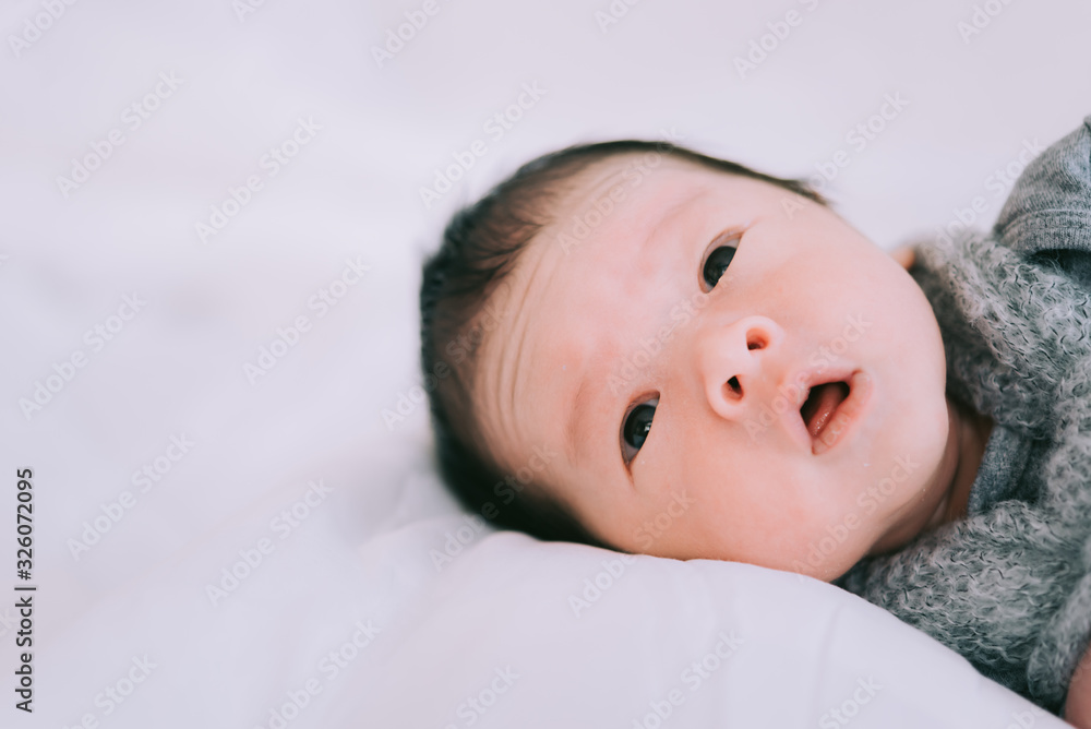 Smiling baby boy lying on a white bed, Family morning at home,Children hygiene. Smiling baby boy lying on a white bed, Family morning at home,Children hygiene.