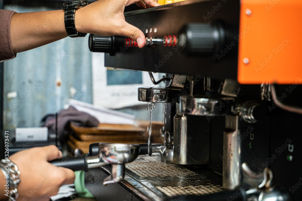 Man hand make coffee by espresso machine hot pouring Man hand make coffee by espresso machine hot pouring